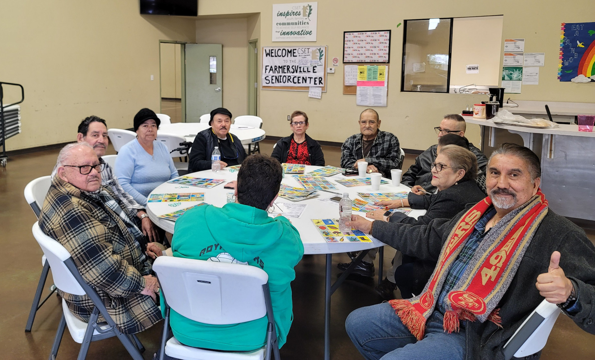 Older adults sitting around the table playing Loteria